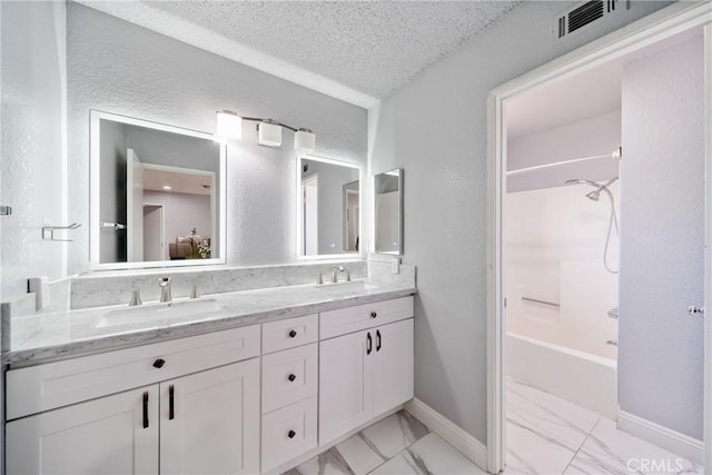 13555 Via, San Remo, Chino Hills, CA 91709 - bathroom featuring double vanity, marble look tile flooring, shower / tub combination, a textured ceiling, and a textured wall