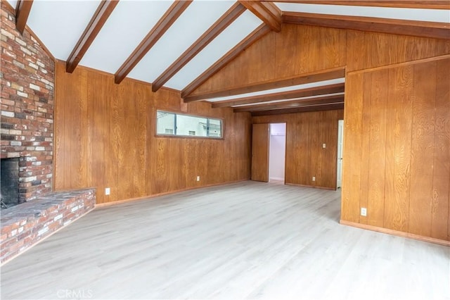 1534 W 154th Pl, Gardena, CA 90247 - unfurnished living room featuring beamed ceiling, wood walls, wood finished floors, a brick fireplace, and high vaulted ceiling