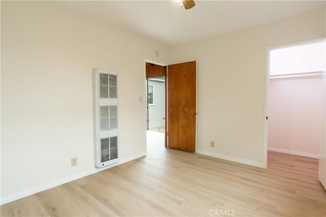 1534 W 154th Pl, Gardena, CA 90247 - unfurnished bedroom featuring a heating unit, light wood-style floors, and a spacious closet
