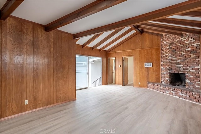 1534 W 154th Pl, Gardena, CA 90247 - unfurnished living room with wooden walls, wood finished floors, and a fireplace