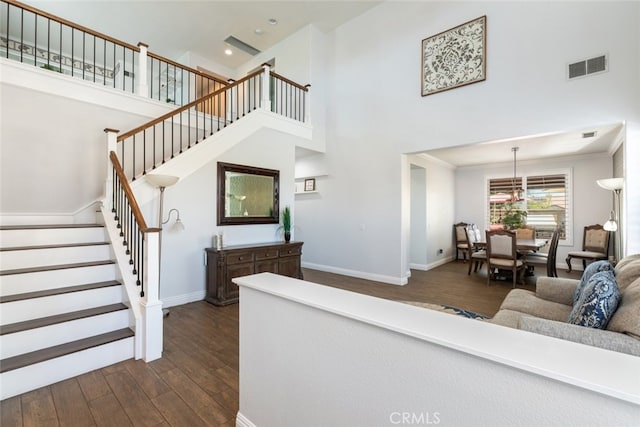 3720 Gunnison Cir, Corona, CA 92881 - living room featuring dark wood finished floors, a towering ceiling, stairs, and recessed lighting