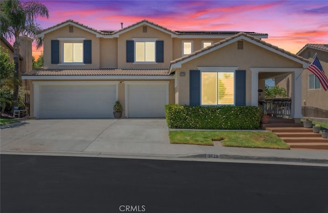 3720 Gunnison Cir, Corona, CA 92881 - view of front of home with stucco siding, an attached garage, a tiled roof, and concrete driveway
