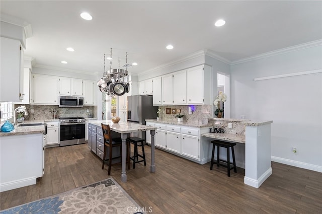 3720 Gunnison Cir, Corona, CA 92881 - kitchen with appliances with stainless steel finishes, a breakfast bar area, white cabinets, decorative backsplash, and ornamental molding