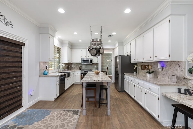 3720 Gunnison Cir, Corona, CA 92881 - kitchen with stainless steel appliances, white cabinets, dark wood-type flooring, a kitchen island, and recessed lighting