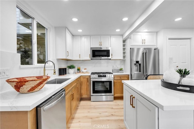 501 Solway St, Glendale, CA 91206 - kitchen featuring stainless steel appliances, light wood-type flooring, white cabinets, recessed lighting, and light countertops