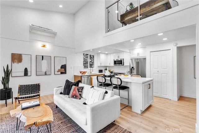501 Solway St, Glendale, CA 91206 - living area with a wall mounted air conditioner, a towering ceiling, light wood-type flooring, and recessed lighting