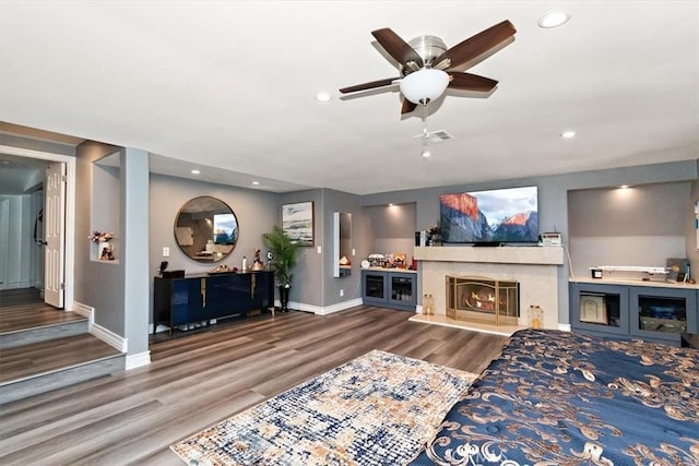 2335 N San Antonio Ave, Upland, CA 91784 - living room with wood finished floors, ceiling fan, a warm lit fireplace, and recessed lighting