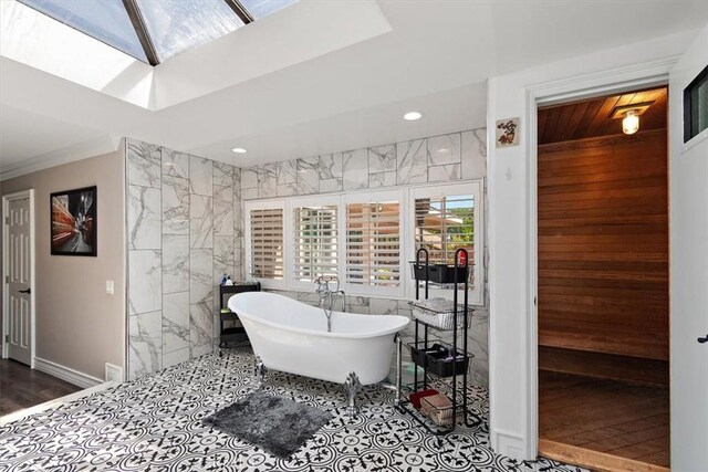 2335 N San Antonio Ave, Upland, CA 91784 - bathroom with a soaking tub, a skylight, recessed lighting, and tile walls