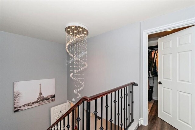 2335 N San Antonio Ave, Upland, CA 91784 - corridor with an upstairs landing and dark wood-type flooring