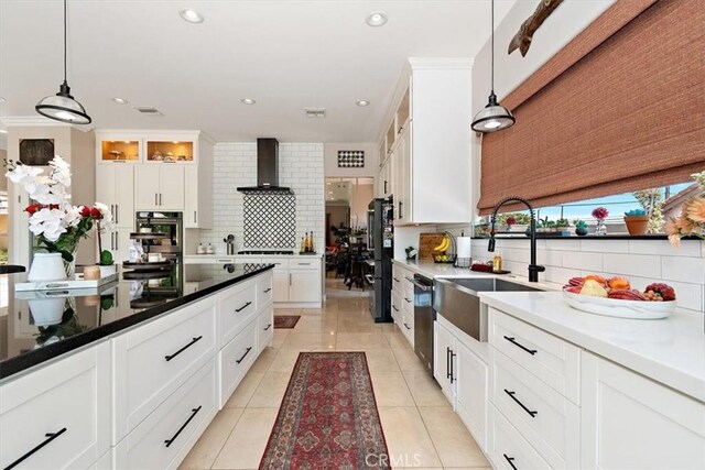 2335 N San Antonio Ave, Upland, CA 91784 - kitchen with backsplash, dishwasher, white cabinetry, freestanding refrigerator, and decorative light fixtures