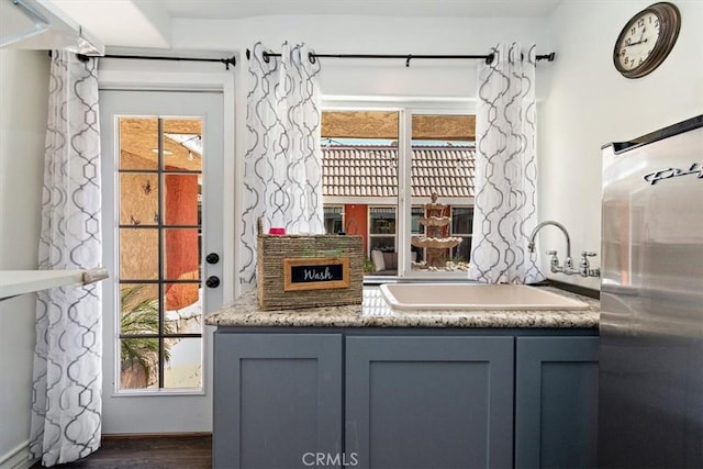 2335 N San Antonio Ave, Upland, CA 91784 - bar area with stainless steel refrigerator and dark wood-style flooring