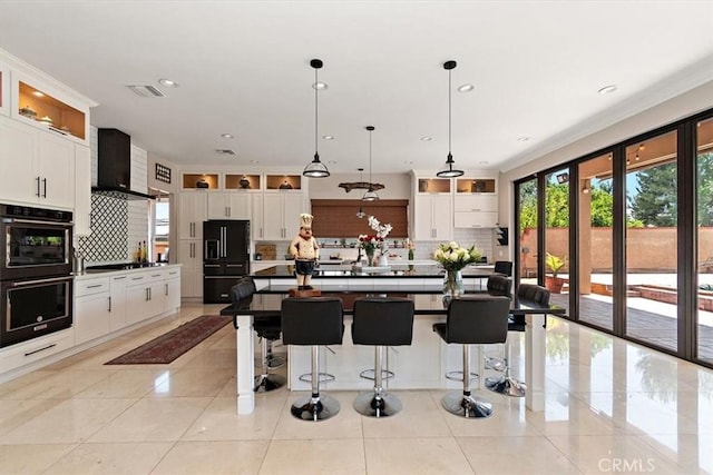 2335 N San Antonio Ave, Upland, CA 91784 - kitchen with wall chimney range hood, black appliances, backsplash, white cabinets, and glass insert cabinets