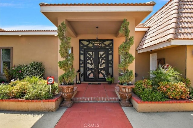 2335 N San Antonio Ave, Upland, CA 91784 - view of exterior entry with stucco siding and a tiled roof