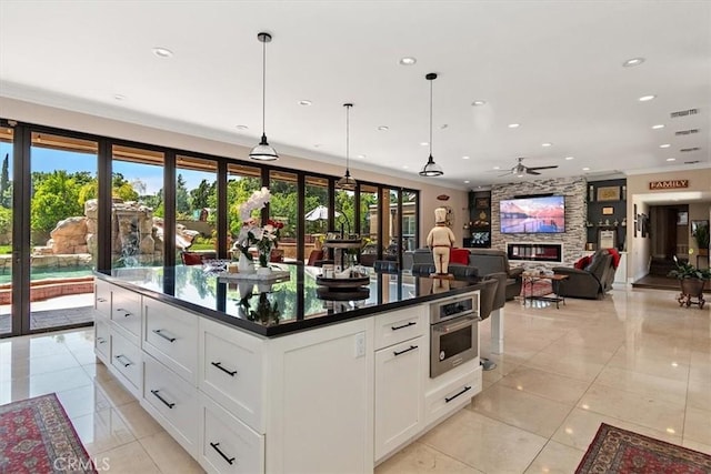 2335 N San Antonio Ave, Upland, CA 91784 - kitchen with stainless steel oven, dark countertops, light tile patterned flooring, a ceiling fan, and recessed lighting