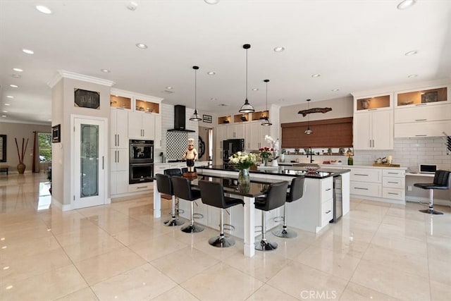 2335 N San Antonio Ave, Upland, CA 91784 - kitchen with decorative backsplash, recessed lighting, a kitchen breakfast bar, white cabinetry, and crown molding