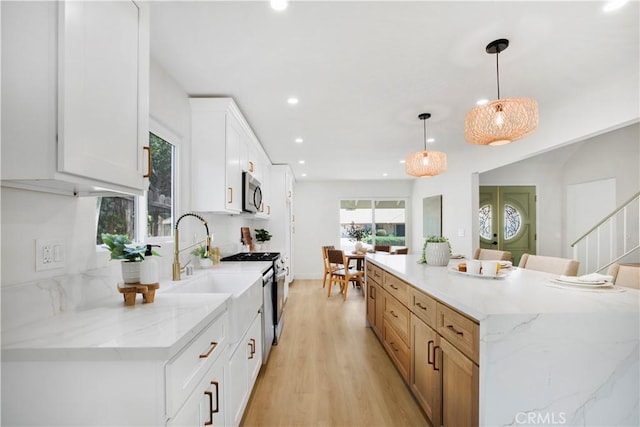801 Navajo Dr, Riverside, CA 92507 - kitchen featuring recessed lighting, a large island, light wood-type flooring, white cabinetry, and decorative light fixtures