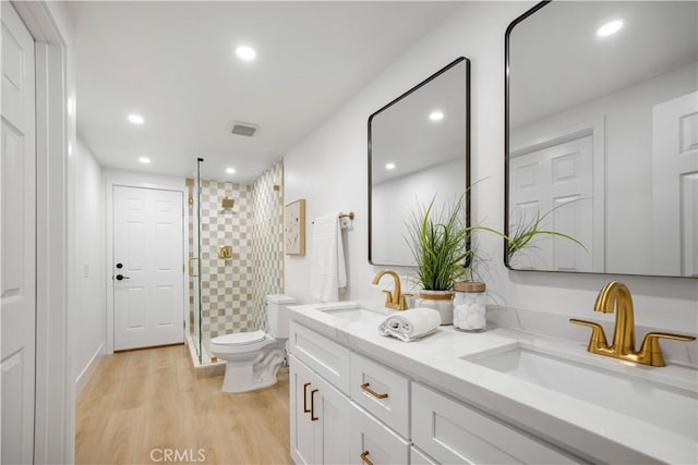 801 Navajo Dr, Riverside, CA 92507 - bathroom with a stall shower, double vanity, wood finished floors, and recessed lighting