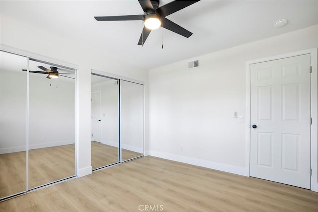 801 Navajo Dr, Riverside, CA 92507 - unfurnished bedroom featuring two closets, light wood finished floors, and ceiling fan