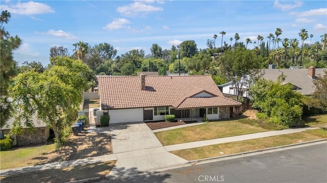 801 Navajo Dr, Riverside, CA 92507 - view of front facade featuring a tiled roof, concrete driveway, an attached garage, and stucco siding