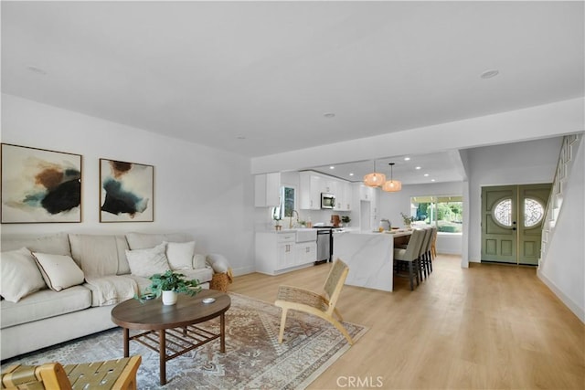 801 Navajo Dr, Riverside, CA 92507 - living room featuring light wood-style floors and recessed lighting