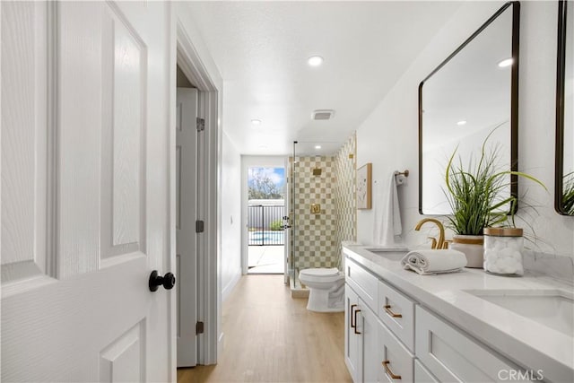 801 Navajo Dr, Riverside, CA 92507 - full bath featuring double vanity, tiled shower, wood finished floors, and recessed lighting