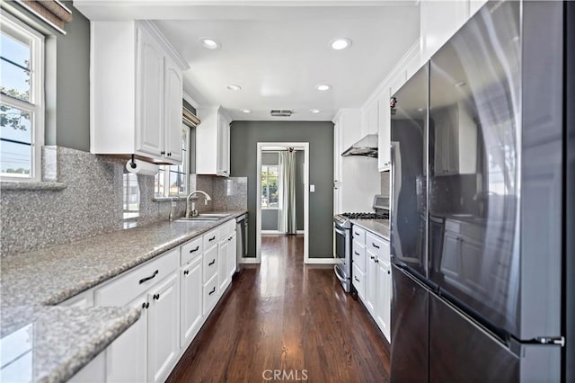 1425 Violeta Dr, Alhambra, CA 91801 - kitchen featuring appliances with stainless steel finishes, white cabinetry, dark wood finished floors, recessed lighting, and extractor fan