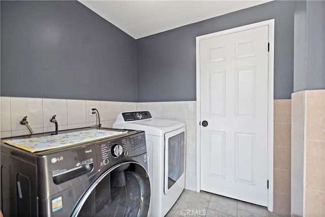 1425 Violeta Dr, Alhambra, CA 91801 - laundry area with tile walls, washing machine and dryer, light tile patterned floors, and wainscoting