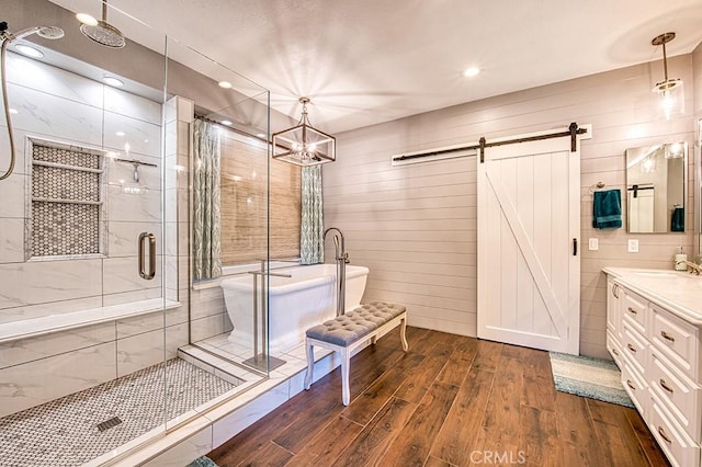 5 Kennedy Ct, Coto De Caza, CA 92679 - bathroom with wood finished floors, vanity, a shower stall, a freestanding bath, and a chandelier
