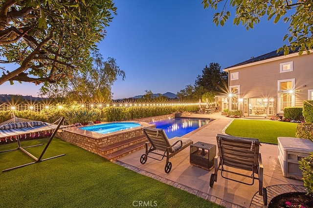 5 Kennedy Ct, Coto De Caza, CA 92679 - pool at dusk featuring an in-ground hot tub, a lawn, a patio, and an outdoor pool
