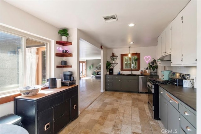 8 Barton Pkwy, Oakdale, CA 95361 - kitchen with stainless steel appliances, white cabinets, dark countertops, recessed lighting, and under cabinet range hood