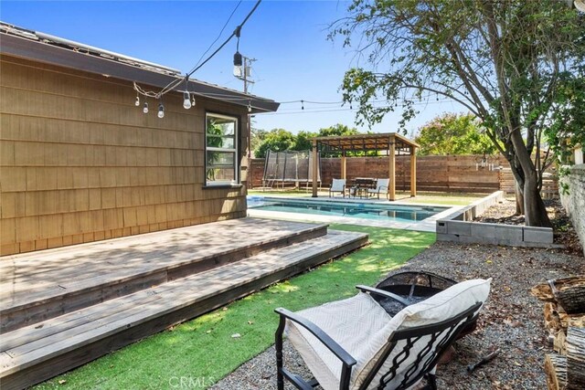 8 Barton Pkwy, Oakdale, CA 95361 - fenced backyard featuring a trampoline, a deck, and a gazebo