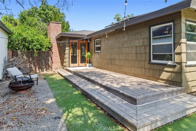 8 Barton Pkwy, Oakdale, CA 95361 - rear view of house featuring a chimney, a fire pit, a wooden deck, and french doors