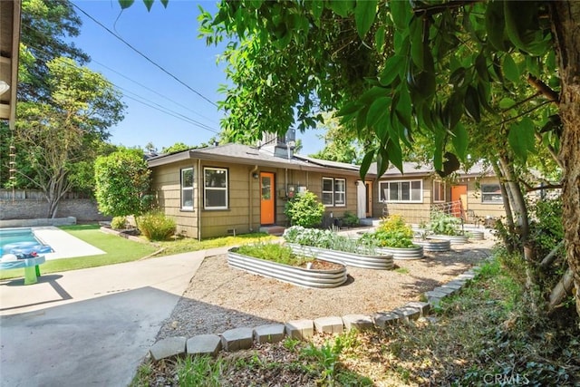 8 Barton Pkwy, Oakdale, CA 95361 - rear view of property featuring a vegetable garden and a patio