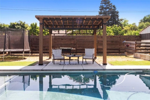 8 Barton Pkwy, Oakdale, CA 95361 - view of swimming pool with a trampoline, a fenced backyard, and a patio area