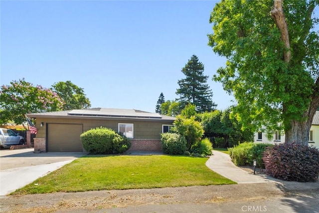 8 Barton Pkwy, Oakdale, CA 95361 - view of front of property with brick siding, an attached garage, driveway, a front yard, and roof mounted solar panels