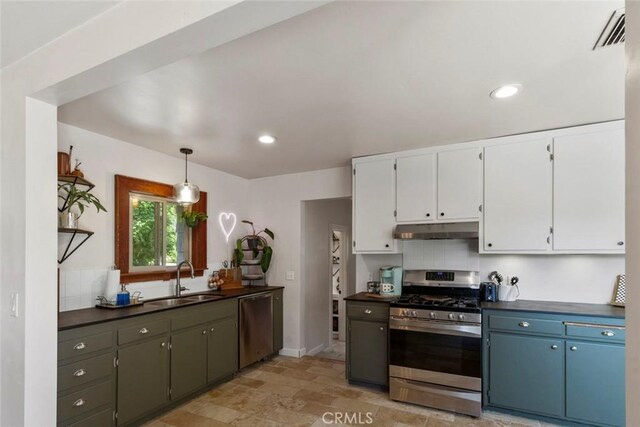 8 Barton Pkwy, Oakdale, CA 95361 - kitchen featuring appliances with stainless steel finishes, under cabinet range hood, dark countertops, white cabinetry, and decorative light fixtures