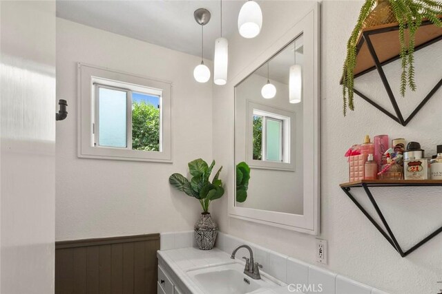 8 Barton Pkwy, Oakdale, CA 95361 - bathroom with vanity, a wainscoted wall, and a textured wall