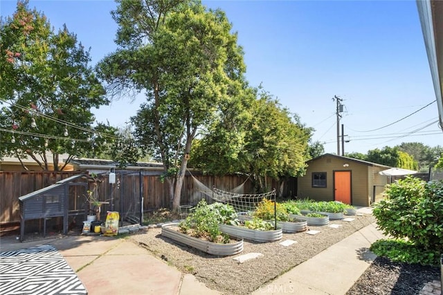 8 Barton Pkwy, Oakdale, CA 95361 - fenced backyard featuring a vegetable garden and an outbuilding