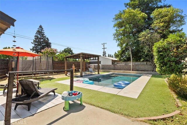 8 Barton Pkwy, Oakdale, CA 95361 - view of swimming pool featuring a fenced backyard, a patio, and a trampoline