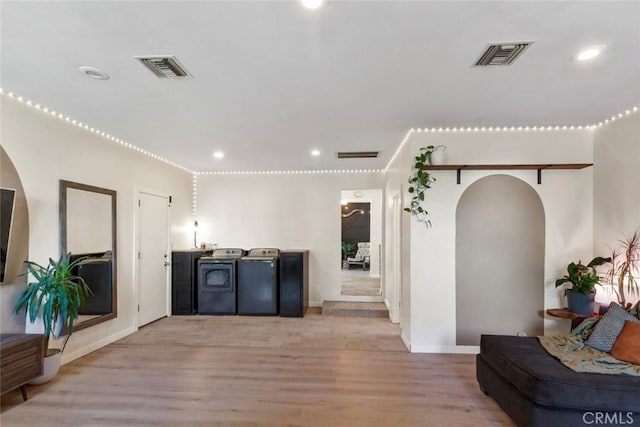8 Barton Pkwy, Oakdale, CA 95361 - living area featuring arched walkways, light wood-style floors, separate washer and dryer, and recessed lighting