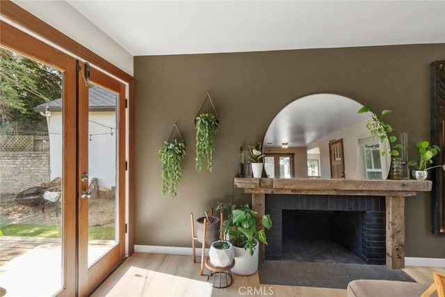 8 Barton Pkwy, Oakdale, CA 95361 - living room featuring french doors, wood finished floors, and a brick fireplace