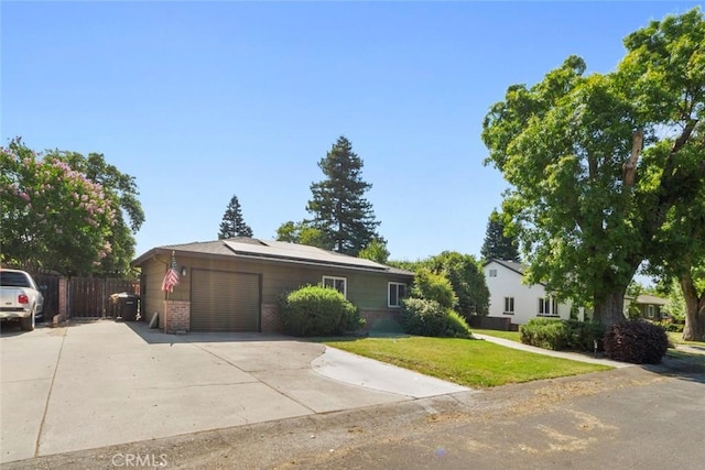 8 Barton Pkwy, Oakdale, CA 95361 - view of front of property featuring a garage, brick siding, driveway, and roof mounted solar panels