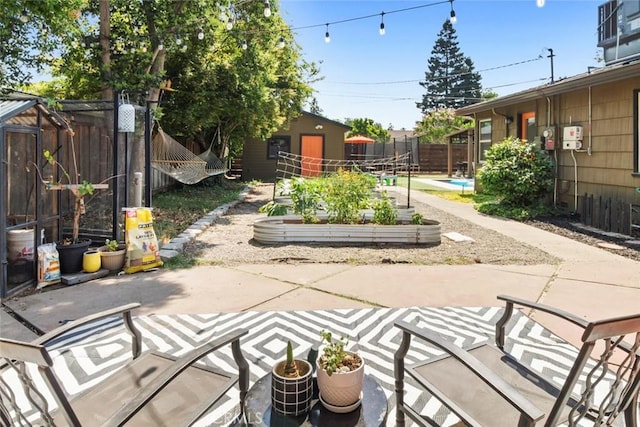 8 Barton Pkwy, Oakdale, CA 95361 - fenced backyard featuring a garden, a patio, and an outdoor structure