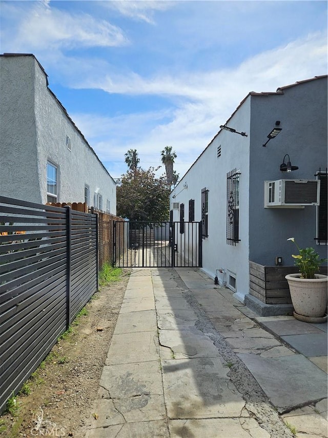1722 W 60th Pl, Los Angeles, CA 90047 - view of concrete surface featuring a gate and a gated entry