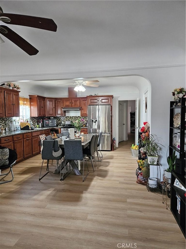1722 W 60th Pl, Los Angeles, CA 90047 - dining space with a ceiling fan, light wood-style flooring, and arched walkways