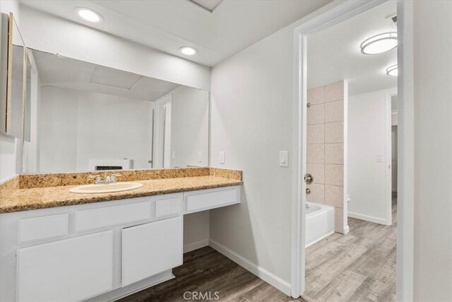 1077 Santo Antonio Dr Unit 54, Colton, CA 92324 - bathroom with wood finished floors, vanity, shower / tub combination, and recessed lighting