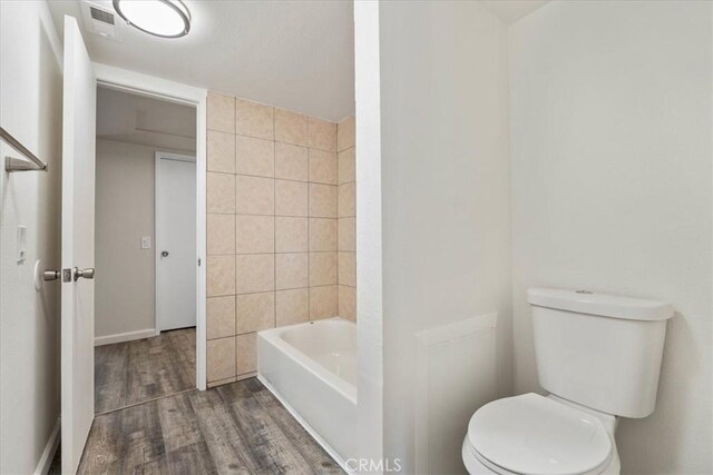 1077 Santo Antonio Dr Unit 54, Colton, CA 92324 - full bathroom featuring toilet and wood finished floors