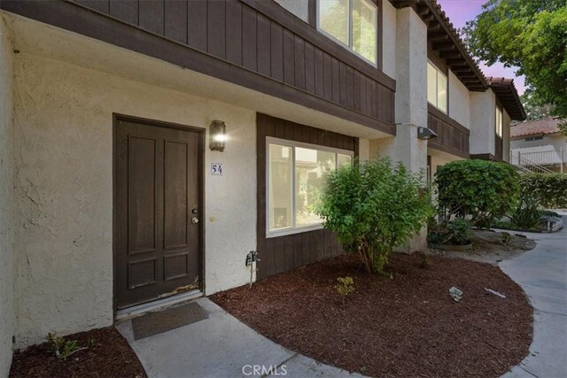 1077 Santo Antonio Dr Unit 54, Colton, CA 92324 - doorway to property with stucco siding