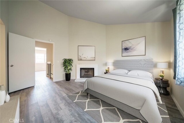1077 Santo Antonio Dr Unit 54, Colton, CA 92324 - bedroom with wood finished floors and a fireplace with raised hearth