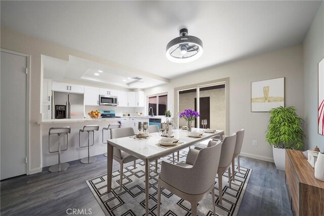 1077 Santo Antonio Dr Unit 54, Colton, CA 92324 - dining area featuring dark wood-style floors and a raised ceiling
